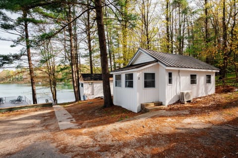 Charming Cabin: Enjoy peaceful summer lake views framed by towering green pines — the perfect setting for sunny lake days, warm evening breezes, and relaxing seasonal escapes ☀️🌲🌊
