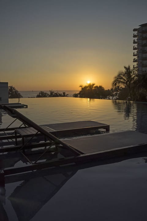Soak in golden-hour calm at the oceanfront infinity pool.