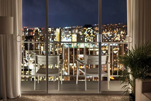 Toast the night as city lights sparkle beyond the glass