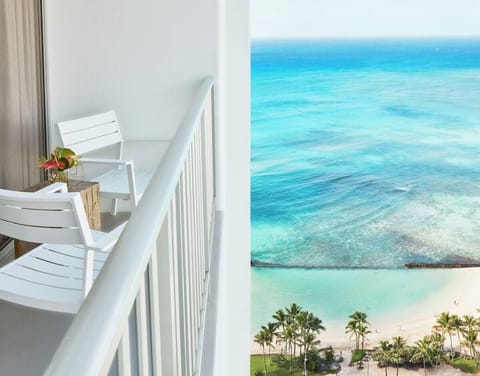 Sip morning coffee on your balcony above turquoise waters.