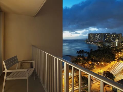 Watch sunset clouds drift over the coastline from your balcony