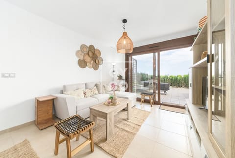 Open-concept living room with plush sofa, natural wood coffee table and stylish rattan accents. Flooded with sunlight, it seamlessly connects to the outdoor terrace for easy indoor-outdoor living 🌞🛋️