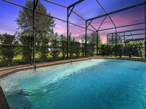 Backyard Patio | Private, screened, heated pool is surrounded by privacy hedges.