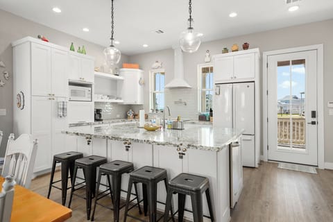 Bar seating at the spacious island in the center of the kitchen