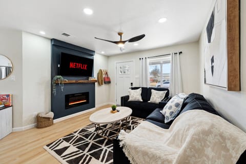 Kick back in this comfy living room with a cozy couch and a big TV, perfect for streaming your favorite shows after a day exploring the Heard Natural Science Museum.