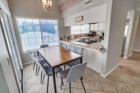 Dining table sitting up against the kitchen bar