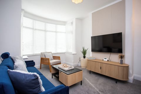 Our inviting living room with a comfortable sofa, a stylish single chair, and a modern center table is the perfect spot to unwind after a day of exploring.
