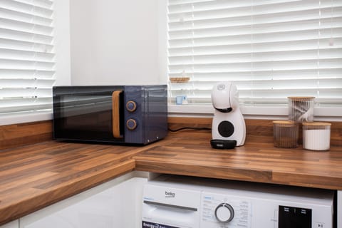 Enjoy the convenience of a microwave oven for easy meal prep and a coffee machine to start your day with the perfect brew.