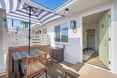 Enjoy your semi-private patio, featuring a table and umbrella, where you can relax and embrace the refreshing ocean breeze.