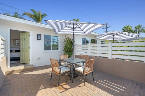Enjoy your semi-private patio, featuring a table and umbrella, where you can relax and embrace the refreshing ocean breeze.