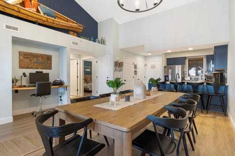 The Open Floor Plan Includes a Dedicated Work Space, a Comfortable Living Area, and a Full Kitchen with Additional Bar Seating