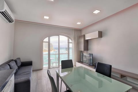 Kitchen / living / dining leading to sea-view private balcony