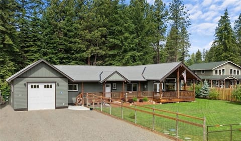 Beautiful fenced in front yard with backyard butting up against a wooded field
