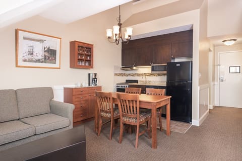 The kitchen and dining space exude a warm and welcoming vibe, encouraging shared meals and delightful conversations around the table.