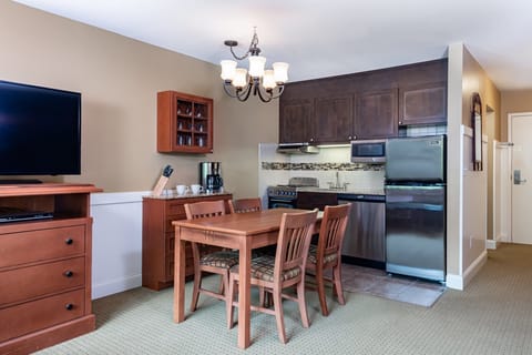 Modern kitchen and dining area with contemporary decor, ideal for preparing and enjoying meals in a stylish setting.