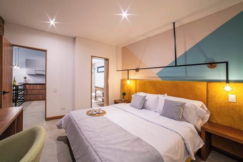 Master Bedroom with King bed, desk and access to private bathroom.