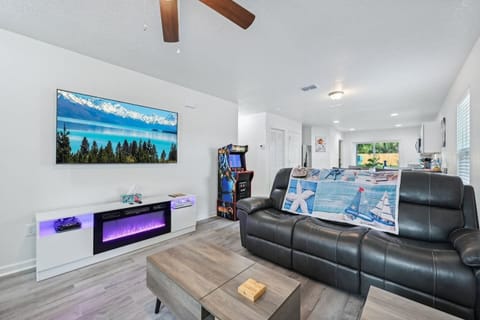 Livingroom with Smart TV, electric fireplace, Xbox, and full size arcade game