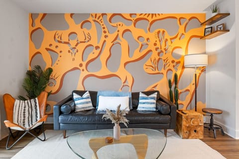 That statement-making mural isn`t just wall art - it`s a conversation starter that makes this living room unlike any other rental in Charleston