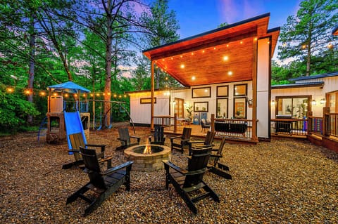 Amazing outdoor space with a playset, firepit area and hot tub