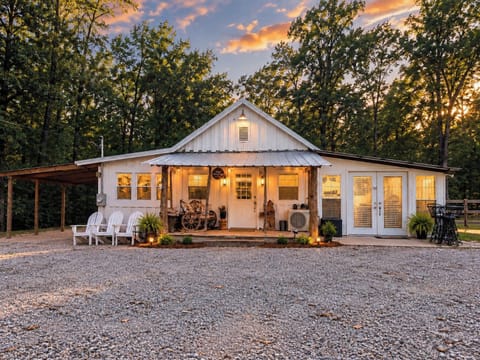 Charming woodland cabin with cozy porch seating at sunset