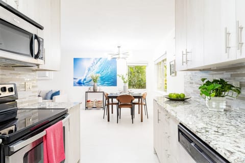 The adjacent full kitchen is equipped with high-end appliances