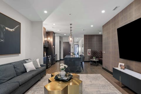 A stylish open-concept living area featuring a plush sectional sofa, modern décor, and warm lighting. Perfect for relaxing after a day in Nashville.