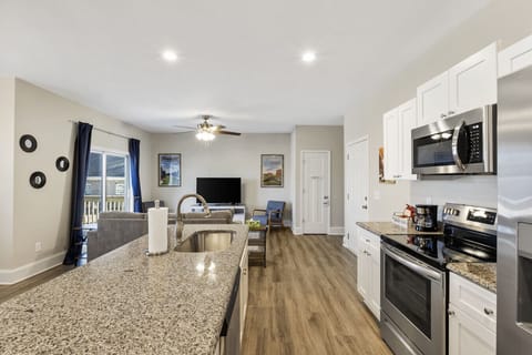 Modern and fully stocked kitchen with sleek granite countertops, stainless steel appliances, and all the essentials for home-cooked meals!