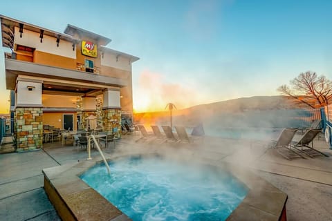 Soothe tired muscles in the bubbling hot tub at dusk.