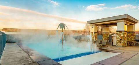 Unwind at sunset in a steamy, resort-style outdoor pool.