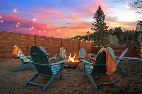 The best moments happen around the fire, under a painted sky.