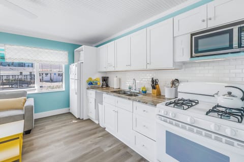Prepare tasty treats for your beach adventures in this well-lit kitchen.