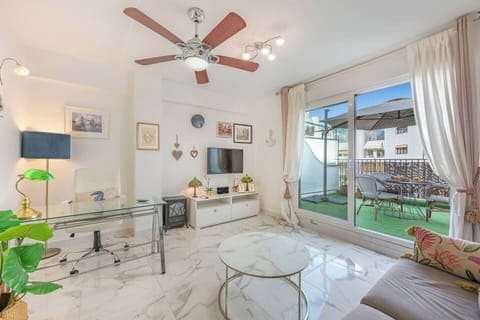 Living Room: Spacious and bright, sofa bed, TV, side table, access to terrace. (1)