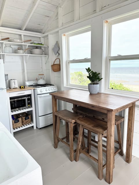 Kitchen with oven, stove, microwave, coffee maker, refrigerator.