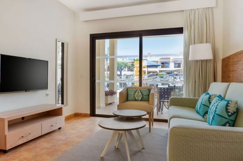 Cozy living room with balcony access, offering a comfortable space