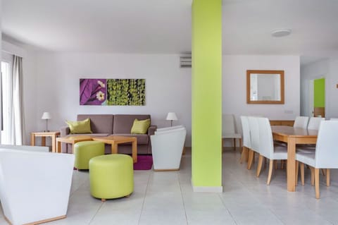Open-plan living and dining area with vibrant accents, perfect for both relaxation and meals.