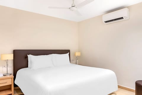 Comfortable and minimalist bedroom with crisp linens for a peaceful sleep.