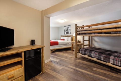 Unwind in a cozy bunk-and-queen room with mini-fridge.