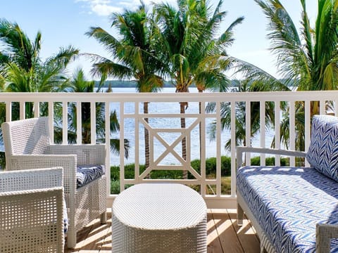 Balcony retreat with cozy seating and tropical views, perfect for soaking up the coastal breeze.