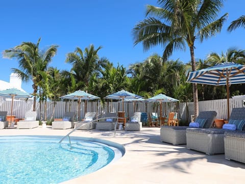 Elegant poolside lounging shaded by swaying palms sets the stage for a relaxing day of indulgence.