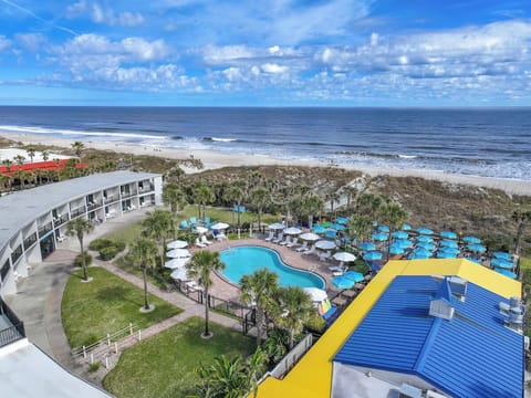 Admire the beachfront pool oasis from a stunning aerial view.