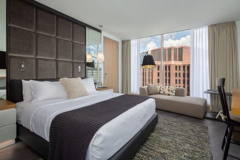 Wake up to skyline views from a plush king bed.