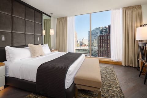 Wake up to sweeping city views from this serene king bedroom.