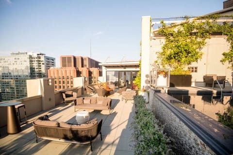 Unwind poolside on the rooftop with skyline scenery.
