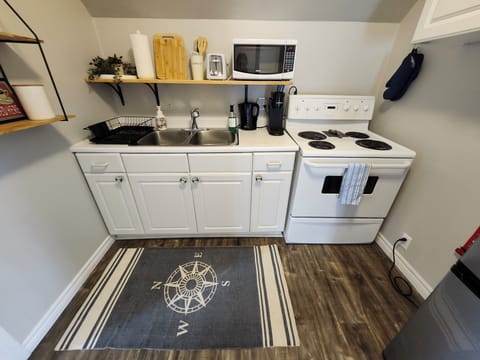 You will find dishes, utensils, some cooking staples, and a mini fridge