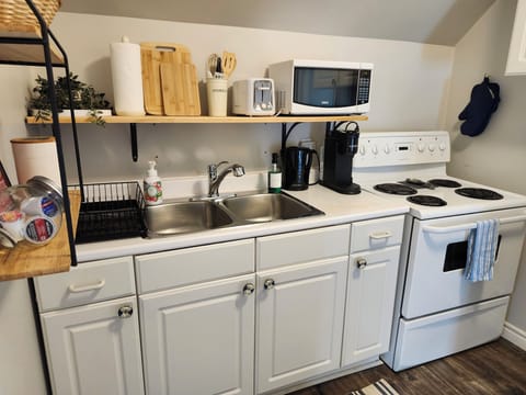 The kitchen features a Keurig coffee machine, microwave, toaster, and kettle