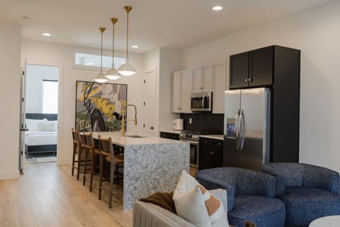 A stylish open-concept living room with modern decor and plenty of natural light.