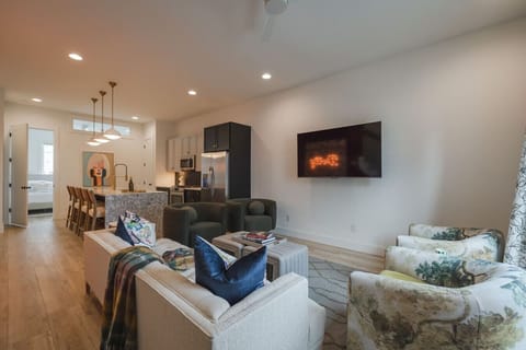 Open-concept living room and kitchen with modern decor.