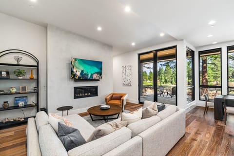 Relax in the inviting great room, where soaring ceilings and large windows flood the space with natural light while framing the picturesque mountain scenery. Cozy up by the fireplace and enjoy the Smart TV.