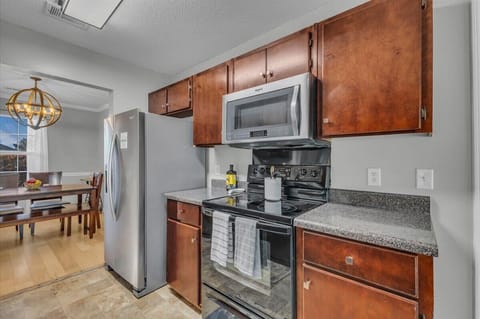 Full kitchen equipped with utensils, Keurig, K-cups, refrigerator, stove, oven, microwave, pots, pans, plates, bowls, glasses, wine glasses, whiskey glasses, blender, grilling utensils, and dishwasher.