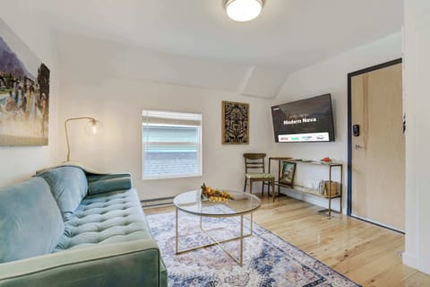 Spacious and stylish living area featuring a plush sofa, Smart TV, and elegant decor—perfect for unwinding or enjoying a cozy night in.
